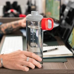 GoBottle with red carry loop on a working desk
