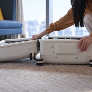 Woman packing a ThinkWay Pro suitcase at home